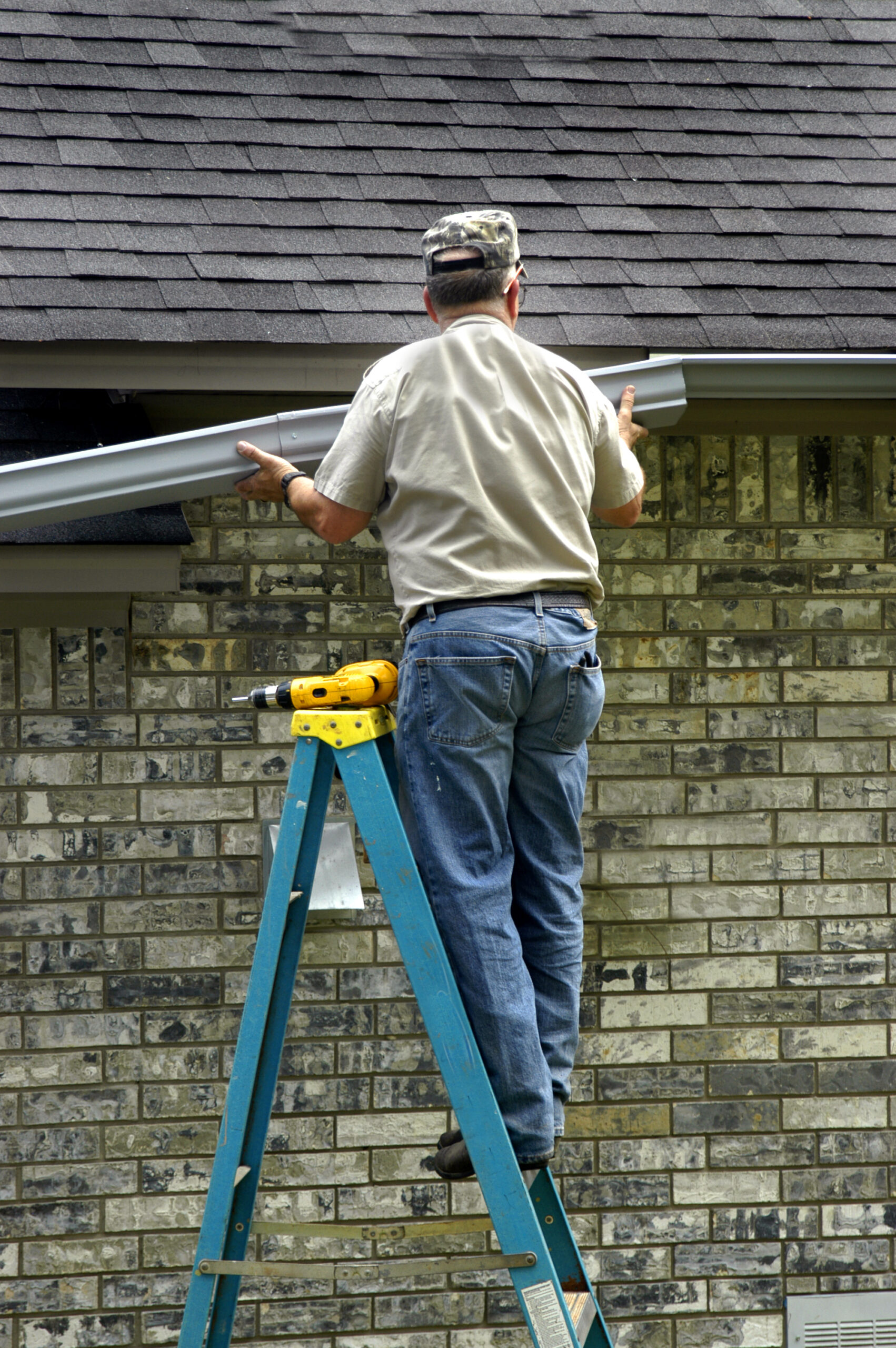 Gutters,Are,Being,Replaced,By,Elderly,Man,On,A,Blue